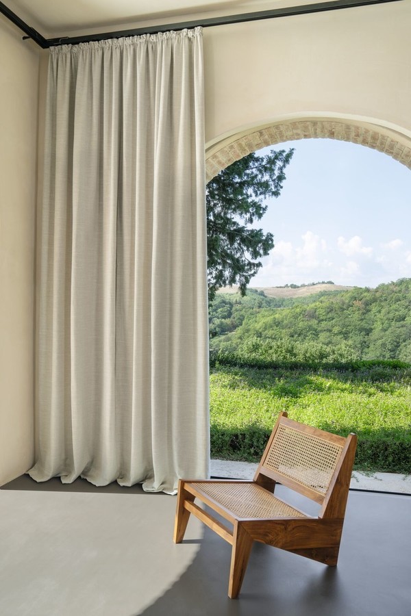 Svetla dekorativna zavesa po meri ob velikem lokovanem oknu z razgledom na naravo